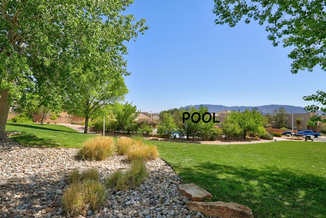 view of community featuring a lawn and a mountain view