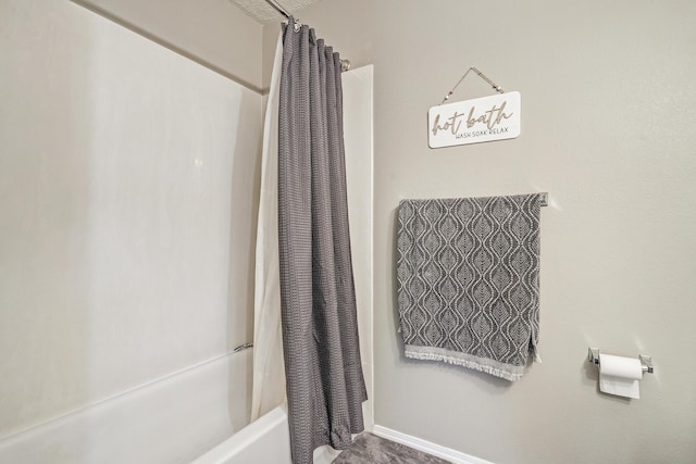 full bathroom featuring baseboards and shower / tub combo