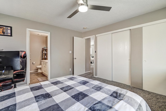 bedroom featuring ensuite bathroom, ceiling fan, a textured ceiling, and a closet