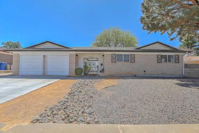 ranch-style house with driveway, a garage, and brick siding