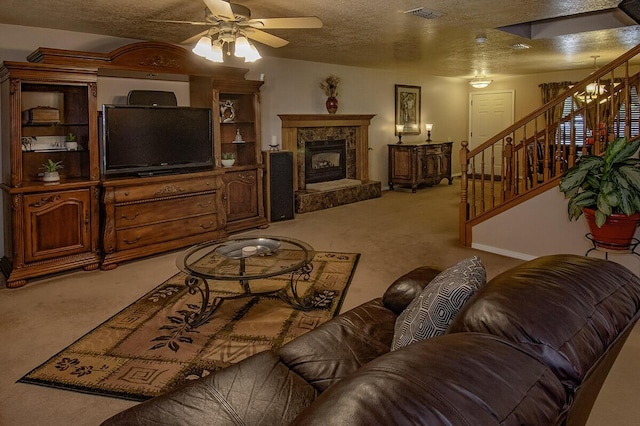 living room with visible vents, a ceiling fan, light carpet, and stairs