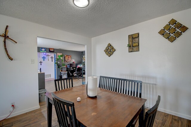 360 Knox Ct, Rio Communities, NM 87002 - dining space with baseboards, a textured ceiling, wood finished floors, and visible vents