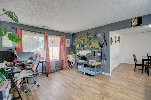 360 Knox Ct, Rio Communities, NM 87002 - office area featuring visible vents, baseboards, a textured ceiling, and wood finished floors