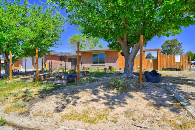 360 Knox Ct, Rio Communities, NM 87002 - view of front of property with brick siding, fence, and a vegetable garden