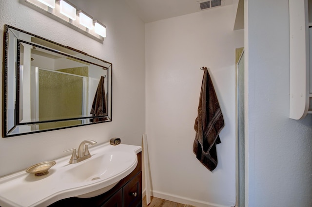 360 Knox Ct, Rio Communities, NM 87002 - bathroom with vanity, a shower stall, wood finished floors, and visible vents