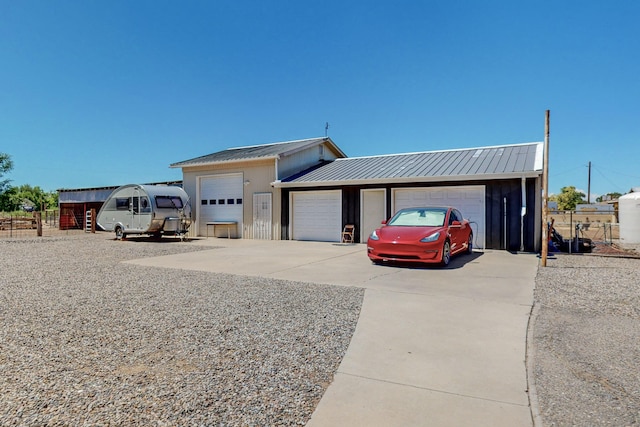38 Elias Rd, Los Lunas, NM 87031 - view of front of property with a metal roof, a detached garage, and driveway