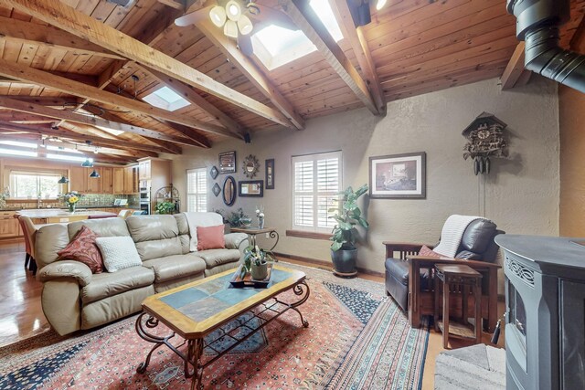 38 Elias Rd, Los Lunas, NM 87031 - living room featuring a skylight, a textured wall, wooden ceiling, and a ceiling fan