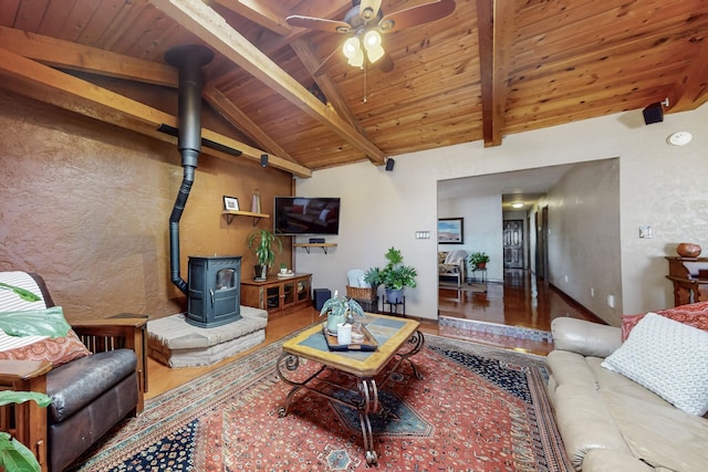 38 Elias Rd, Los Lunas, NM 87031 - living area featuring a wood stove, wood finished floors, wood ceiling, a ceiling fan, and a textured wall