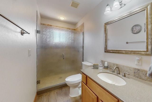 630 Barnett Rd, Bosque Farms, NM 87068 - full bath featuring a stall shower, toilet, vanity, and wood finished floors