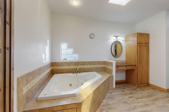 630 Barnett Rd, Bosque Farms, NM 87068 - bathroom with a tub with jets and wood finished floors