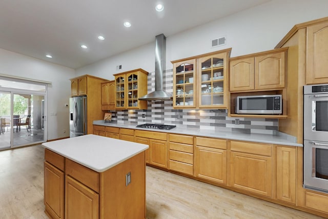 630 Barnett Rd, Bosque Farms, NM 87068 - kitchen featuring stainless steel appliances, wall chimney range hood, light wood-style floors, tasteful backsplash, and recessed lighting