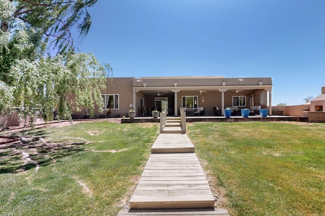 630 Barnett Rd, Bosque Farms, NM 87068 - rear view of property with a ceiling fan, an outdoor living space, stucco siding, and a patio area