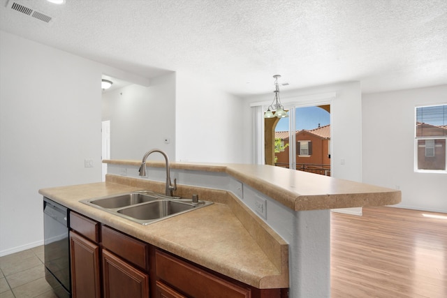 kitchen with black dishwasher, plenty of natural light, a sink, and visible vents