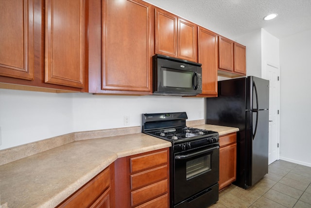 kitchen with light tile patterned floors, black appliances, brown cabinetry, and light countertops