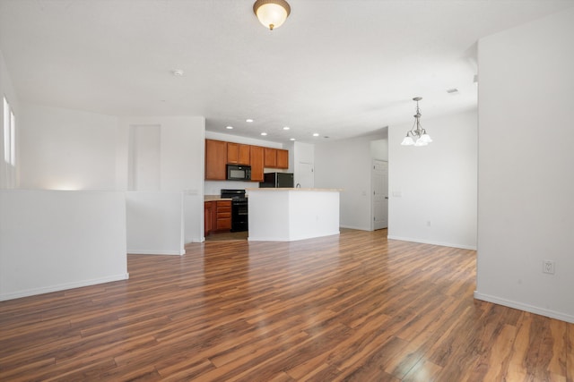 unfurnished living room with baseboards, recessed lighting, a notable chandelier, and dark wood-style flooring