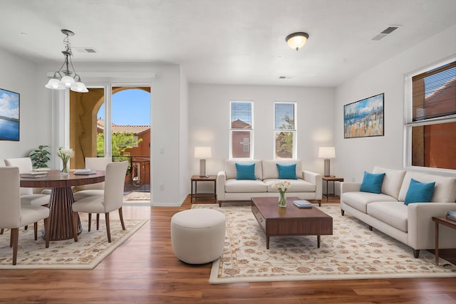 living area featuring visible vents, wood finished floors, and a wealth of natural light