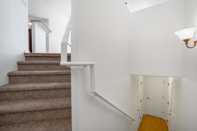 stairway featuring a skylight