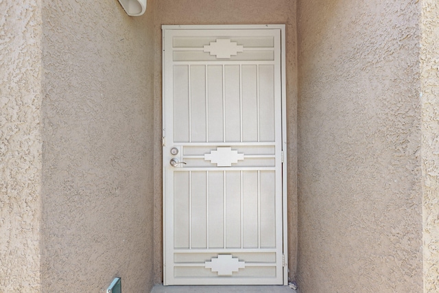 doorway to property with stucco siding