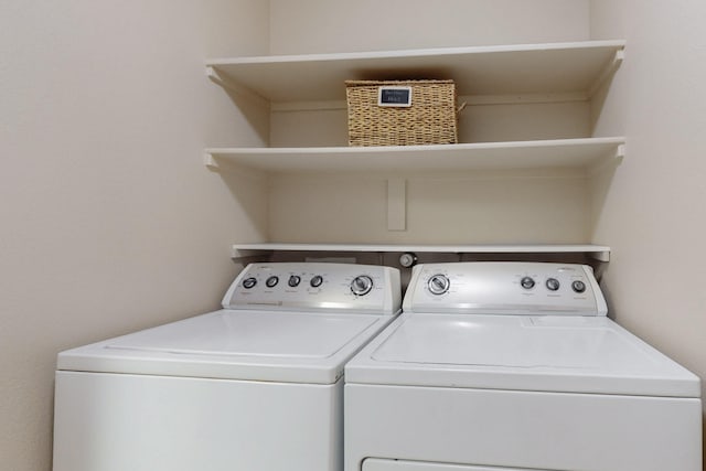 clothes washing area featuring laundry area and washing machine and dryer