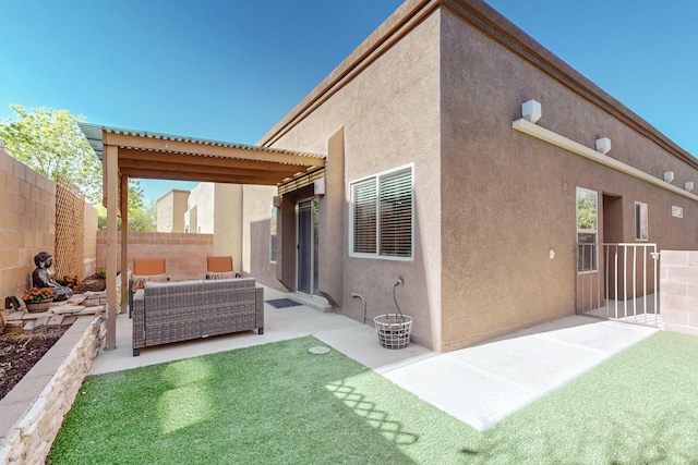 back of property with an outdoor hangout area, a fenced backyard, a patio area, and stucco siding