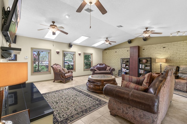 7 Wildwood Ln, Peralta, NM 87042 - tiled living room featuring visible vents, ceiling fan, lofted ceiling with skylight, and brick wall