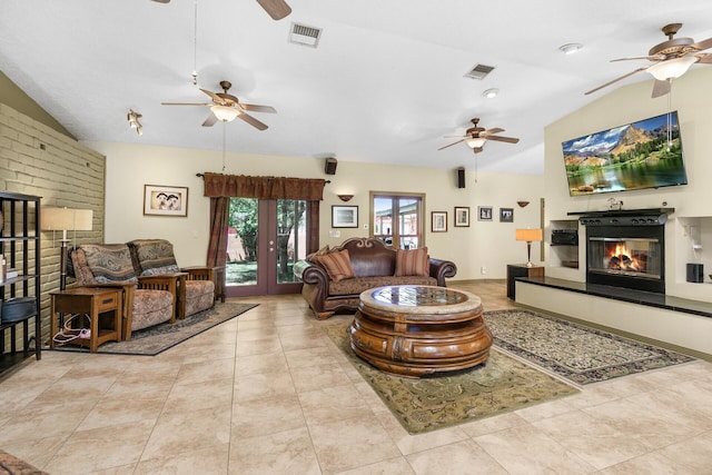 7 Wildwood Ln, Peralta, NM 87042 - tiled living area with visible vents, vaulted ceiling, a ceiling fan, and a glass covered fireplace