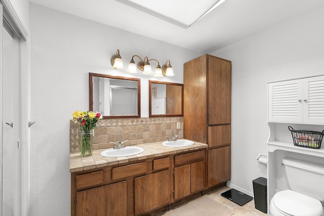7 Wildwood Ln, Peralta, NM 87042 - bathroom featuring backsplash, toilet, double vanity, and a sink