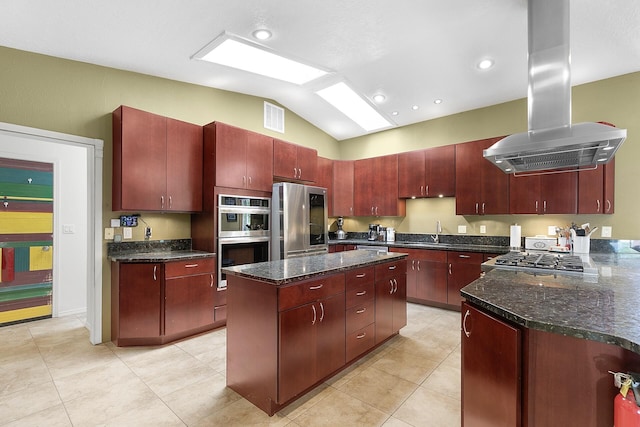 7 Wildwood Ln, Peralta, NM 87042 - kitchen featuring island range hood, a sink, reddish brown cabinets, and appliances with stainless steel finishes