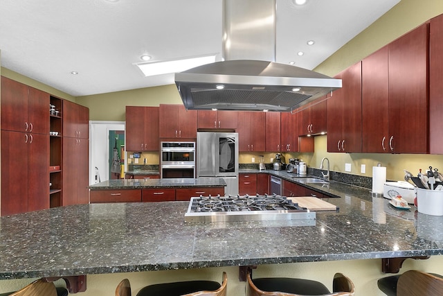 7 Wildwood Ln, Peralta, NM 87042 - kitchen featuring island range hood, appliances with stainless steel finishes, dark brown cabinets, a sink, and a peninsula