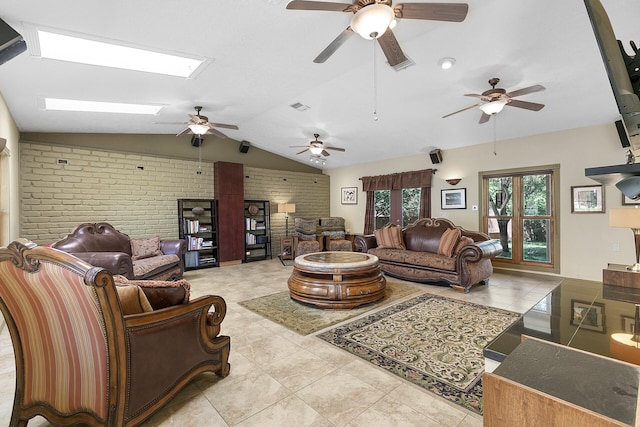 7 Wildwood Ln, Peralta, NM 87042 - living room featuring vaulted ceiling with skylight, brick wall, light tile patterned floors, a ceiling fan, and visible vents
