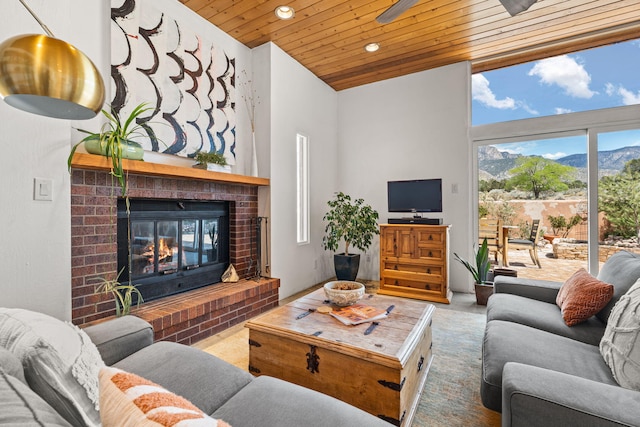 living room with recessed lighting, a high ceiling, wood ceiling, and a fireplace