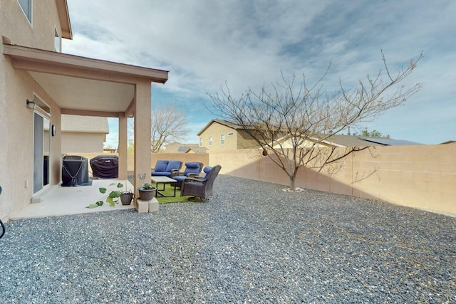 view of yard featuring outdoor lounge area, a patio, and a fenced backyard