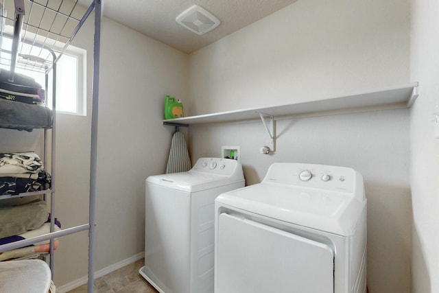 laundry area featuring baseboards, laundry area, and washing machine and dryer