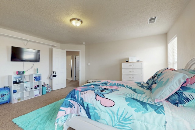 carpeted bedroom with a textured ceiling and visible vents