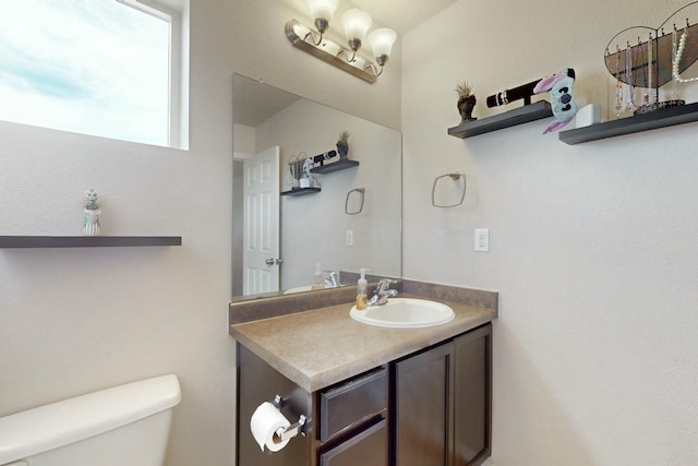 half bath featuring toilet and vanity