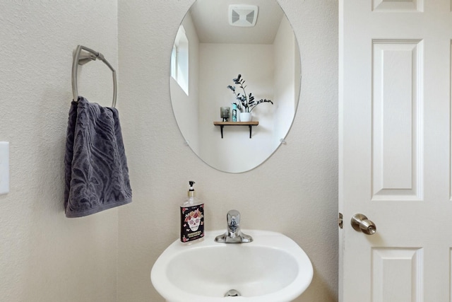 bathroom featuring visible vents and a sink