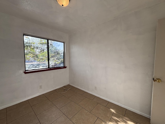 tiled empty room with baseboards