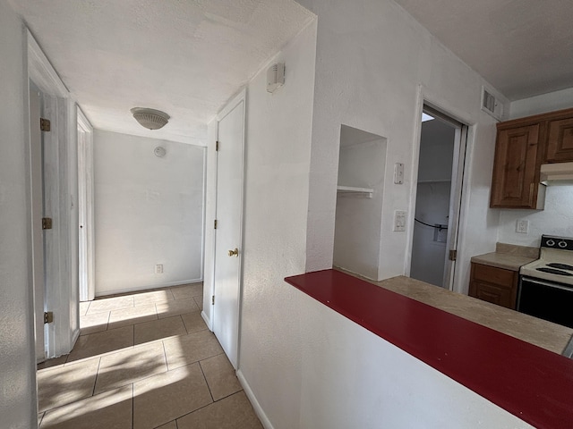 hall with visible vents and tile patterned flooring