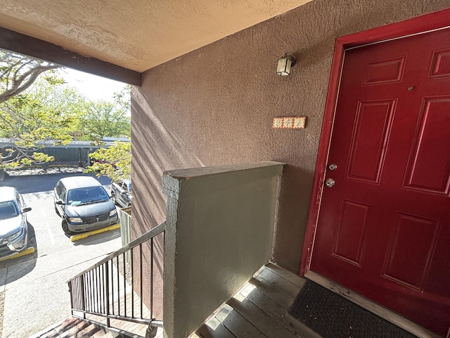 entrance to property featuring stucco siding