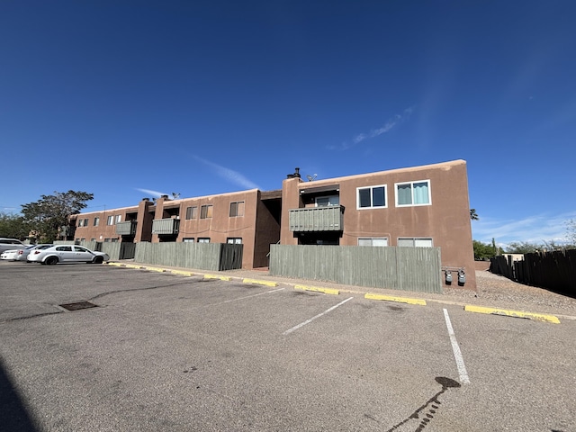 view of property with uncovered parking