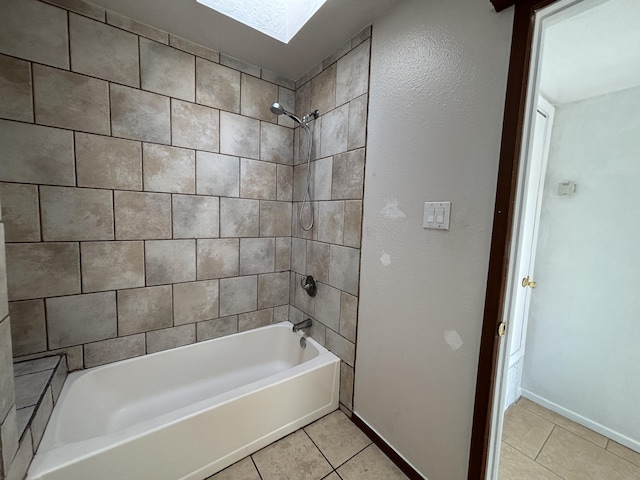 full bath featuring tub / shower combination, tile patterned flooring, a skylight, and baseboards