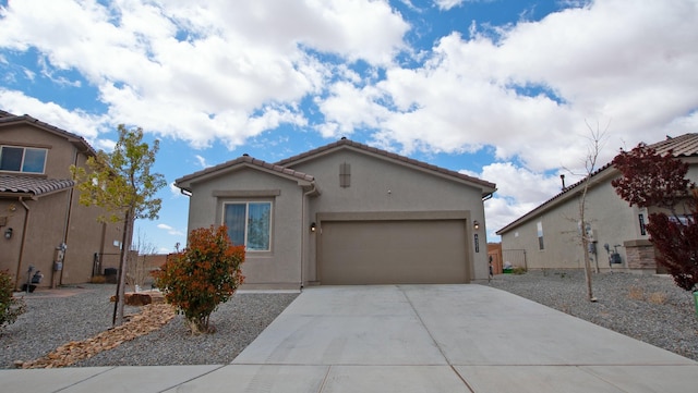 4321 Skyline Loop NE, Rio Rancho, NM 87144 - view of front facade with concrete driveway, a garage, stucco siding, and a tile roof