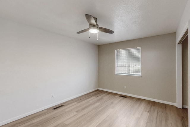 308 Garden Ave SW, Los Lunas, NM 87031 - unfurnished bedroom featuring baseboards, visible vents, light wood finished floors, and a closet
