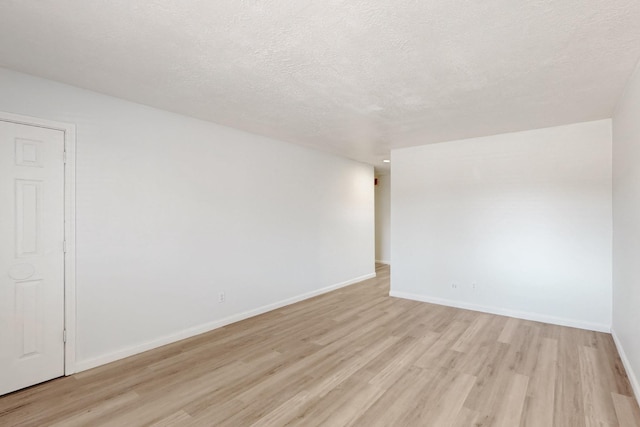 308 Garden Ave SW, Los Lunas, NM 87031 - spare room featuring baseboards, light wood-type flooring, and a textured ceiling