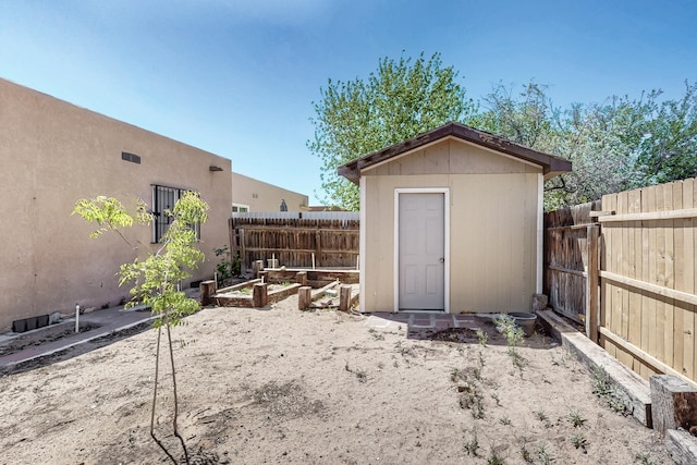 308 Garden Ave SW, Los Lunas, NM 87031 - view of shed with a fenced backyard and a vegetable garden