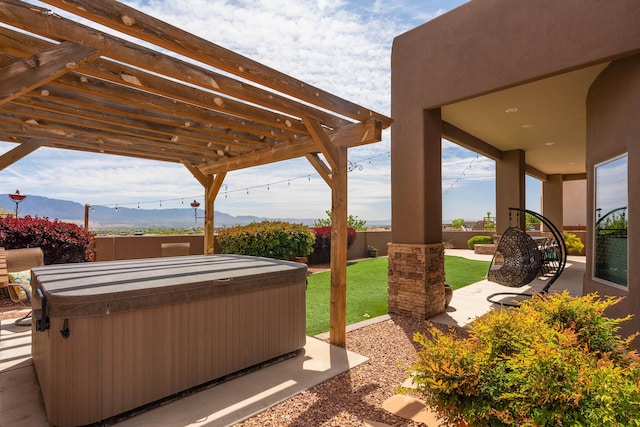 view of patio featuring a mountain view, a pergola, a fenced backyard, and a hot tub
