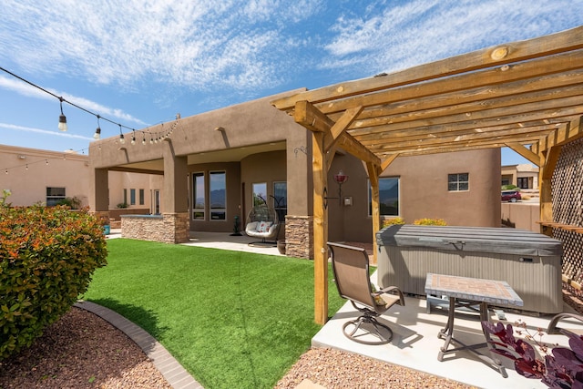 rear view of property featuring a patio area, a hot tub, a pergola, a lawn, and stucco siding