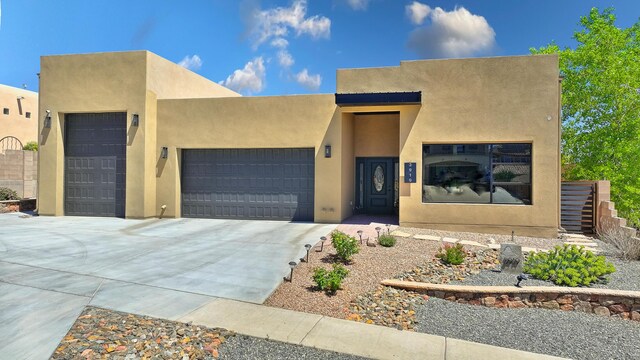 3919 Bryan Ave NW, Albuquerque, NM 87114 - southwest-style home featuring an attached garage, stucco siding, and concrete driveway