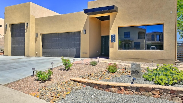 3919 Bryan Ave NW, Albuquerque, NM 87114 - pueblo-style house with a garage, stucco siding, and concrete driveway