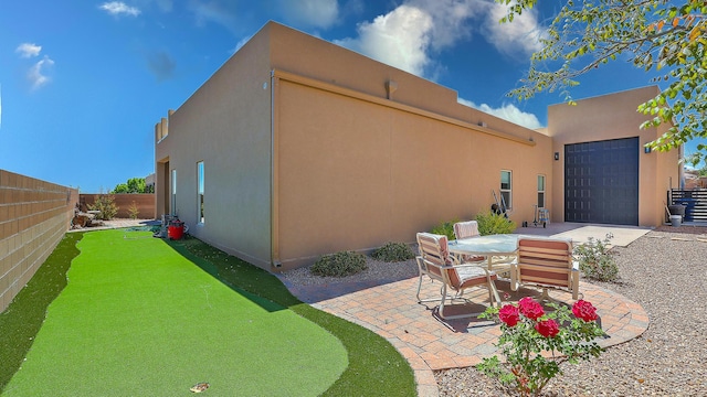 3919 Bryan Ave NW, Albuquerque, NM 87114 - fenced backyard featuring a patio area and an attached garage